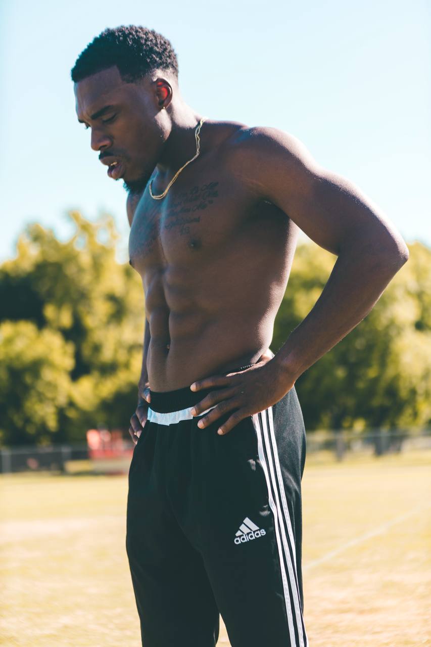 Udoka on a sports field, hands on his hips, catching his breath